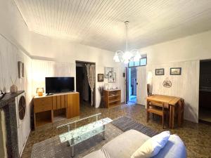 a living room with a couch and a tv at Piccolo Borgo vista lago di Como by Gottschalk in Dorio +21 photos