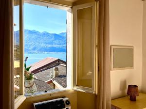 a window with a view of a mountain at Piccolo Borgo vista lago di Como by Gottschalk in Dorio