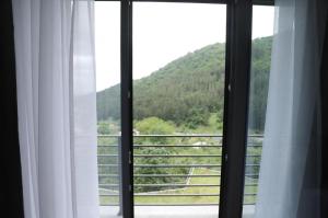 a window with a view of a mountain at Aleksberg Club, Dilijan Hotel in Dilijan