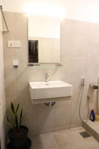 a bathroom with a sink and a mirror at Bunk 7 in Kandy