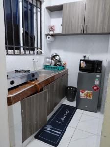 a small kitchen with a sink and a refrigerator at Havy Homes in Bamburi +9 photos