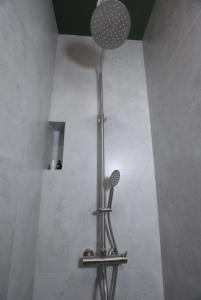 a shower with a shower head in a bathroom at Aleksberg Club, Dilijan Hotel in Dilijan