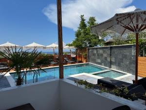 a swimming pool with a view of the ocean at Vila Jeti in Ksamil