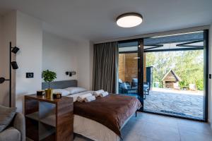 a bedroom with a bed and a large glass window at Kosmaj Apartmani Košutica - Marija i Ksenija in Koraćica +53 photos