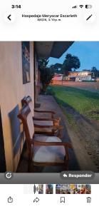 a row of benches sitting next to a building at Casa Artavia in Tortuguero