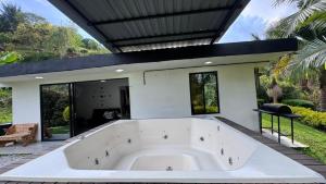 a large white bath tub in a house at Lisboa Hause in Horizonte