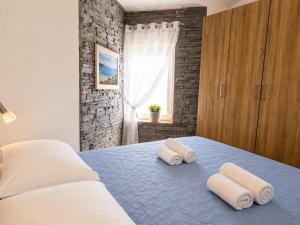 a bedroom with a bed with towels on it at Adriatic Star in Banjol +99 photos