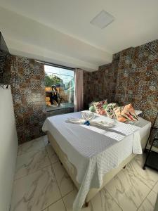 a bedroom with a bed with a table and a window at Pousada e Restaurante Morena Raiz in Olinda +78 photos