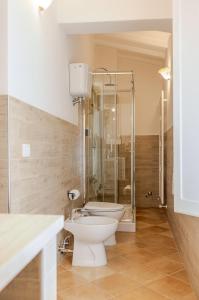 a bathroom with a toilet and a glass shower at La Casa delle Farfalle in Chiusi +24 photos