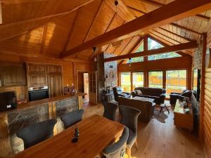 a living room with a table and chairs in a cabin at Violetta Cottage in Užice