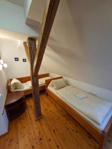 a room with two beds and a tree in it at Hostinec u Janatů s ubytováním in Čestín +59 photos