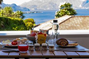 a table with food and drinks on a table with a view at B&B Belvedere in Colico