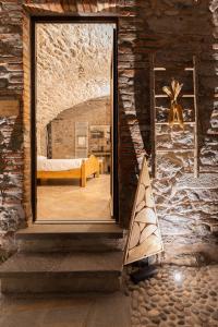a room with a large window in a stone wall at Antica corte in Zogno