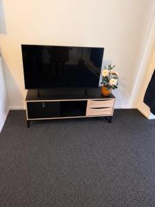 a flat screen tv sitting on a entertainment center at Finstay Turku in Turku