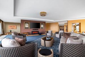 a living room with couches and a flat screen tv at InterContinental Grand Ankara by IHG in Ankara