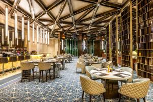 a restaurant with tables and chairs in a library at InterContinental Grand Ankara by IHG in Ankara