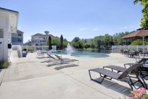 a group of chairs and a pool with a fountain at 36967 S. Silver Sands Dr, Bethany Beach in Bethany Beach