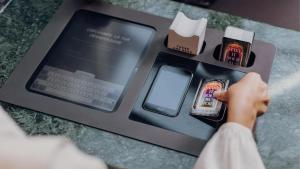 a person is using a cash register with a computer at Ruby Louise Hotel Frankfurt by IHG in Frankfurt