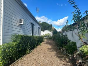 a gravel path next to a house with a building at The Hunter Studio in Cessnock
