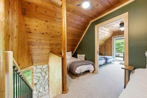 a bedroom in a log cabin with two beds at Crystal Cabin on the Betsie in Thompsonville