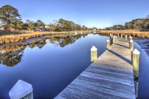 a wooden bridge over a river with trees in the background at 11 Mooring La in Millville +42 photos