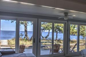 a room with sliding glass doors with a view of the ocean at 229 Bay Ave. in Milford
