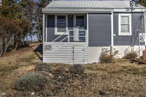 a small house with the door open in a yard at 229 Bay Ave. in Milford