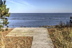 a wooden path leading to the ocean on a beach at 229 Bay Ave. in Milford