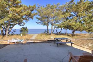 a picnic table and a bench on the beach at 229 Bay Ave. in Milford
