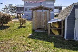 a wooden outhouse with a roof on a yard at 229 Bay Ave. in Milford +41 photos