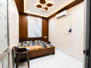 a bedroom with a bed and a ceiling fan at Maa janki paying guest house near Ram mandir in Ayodhya