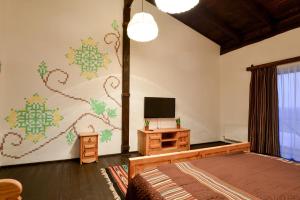 a bedroom with a bed and a tv on a wall at Hotel Skrinya in Pavlohrad