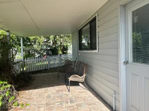a porch with two chairs and a door at The Hunter Studio in Cessnock