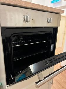 an oven with its door open in a kitchen at MartiniRoom Signature in Glauchau