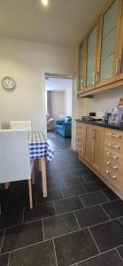 a kitchen with a table and a counter top at Flat 21 - 1st floor - Westview Terrace, Stornoway in Stornoway
