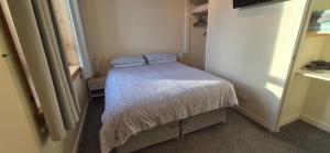 a small bedroom with a small bed in a room at Flat 21 - 1st floor - Westview Terrace, Stornoway in Stornoway