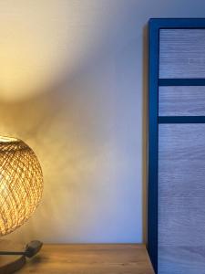 a lamp sitting next to a wall next to a mirror at Regium Studio in Nikiana