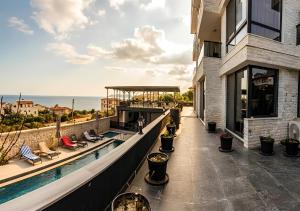 a balcony of a building with a swimming pool at Beyaz Kosk in Demre
