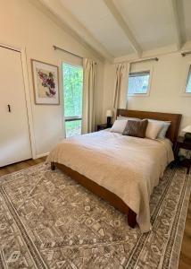 a bedroom with a bed and a large window at Manville Heights Modern in Iowa City
