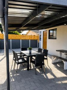 a patio with a table and chairs under awning at 60 On Kosmos in Bellville South +7 photos