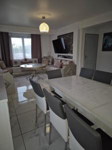 a living room with a large marble table and chairs at BELLE MAISON A Ménars in Menars