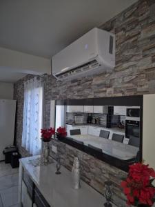a kitchen with a stone wall with a wall mounted oven at BELLE MAISON A Ménars in Menars