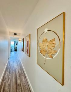 a hallway with a large painting of a leaf on the wall at Balcony Lake Views - Pool, Gym, WiFi & Parking in Orlando