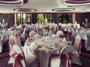 a banquet hall with white tables and chairs in a room at Mercure Hull Grange Park Hotel in Hull +133 photos