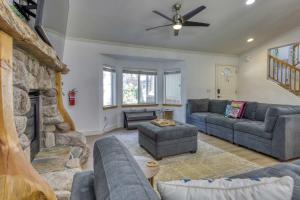 a living room with couches and a stone fireplace at Tahoe Forest Haven in South Lake Tahoe