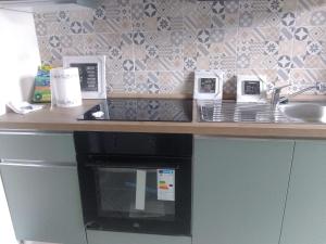 a kitchen with a counter top with a microwave at Casa Rosa in Vigevano
