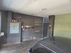 an empty garage with a car parked in it at loft 2 em Salto Acomoda até 4 pessoas rede urbana in Salto +17 photos