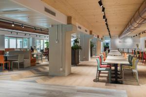 a row of tables and chairs in a cafeteria at Ostello Sport Center in Monte Ceneri