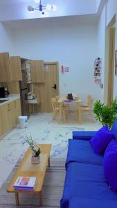 a living room with a blue couch and a table at Little friend #1 Two balconies,elevator in Boca Chica