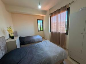 a bedroom with a bed and a window at Batroun sunset guesthouse in Batroûn